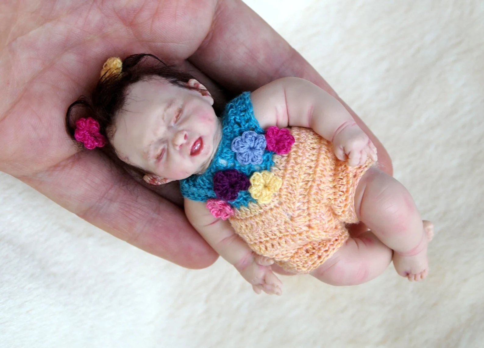 Digital PDF crochet pattern for an adorable baby romper for OOAK mini baby dolls, featuring step-by-step instructions and pictures.