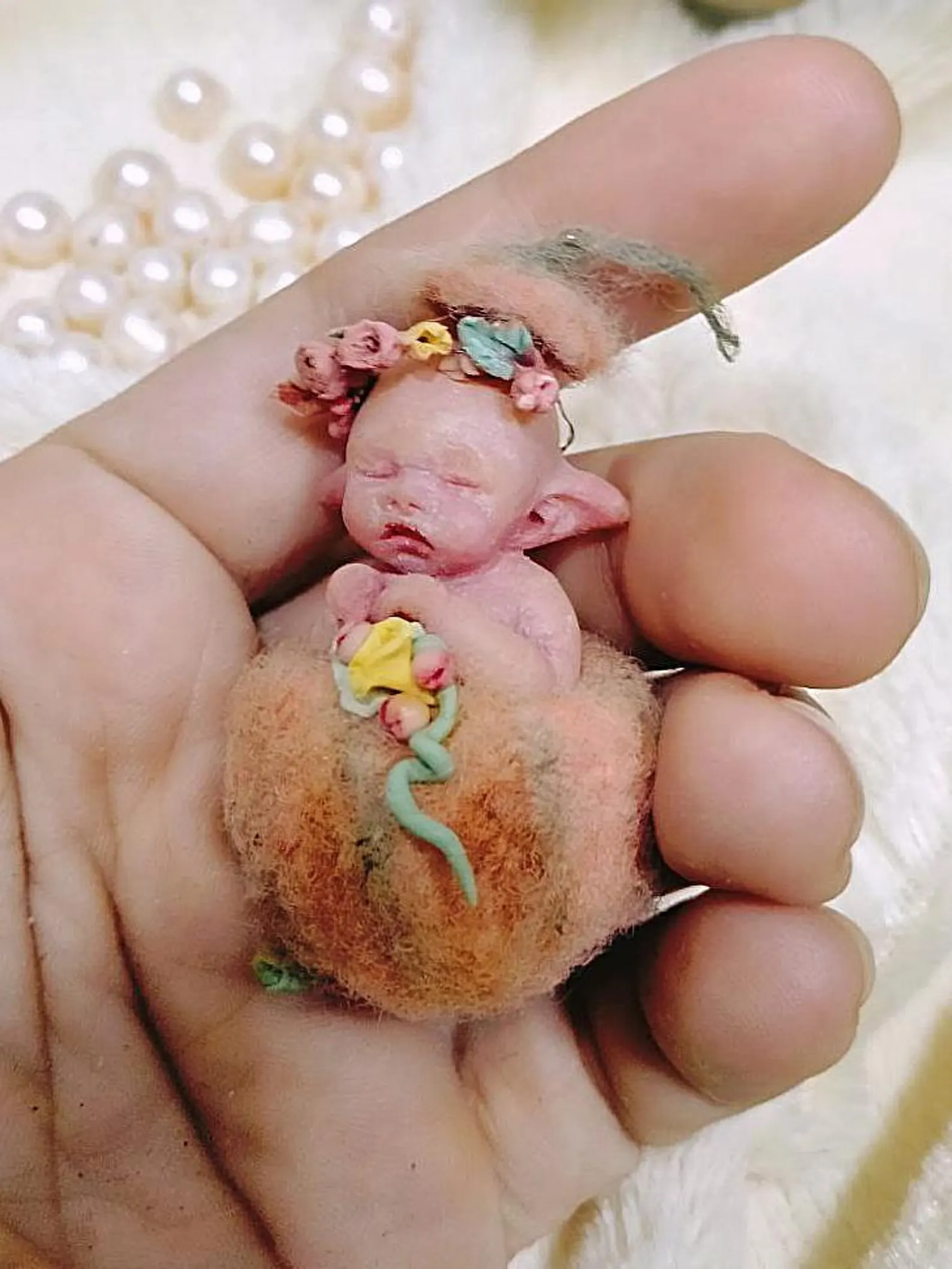 Pumpkin Elf: 1:12 scale anatomically correct micro baby doll. Hand-painted resin art doll with removable wool pumpkin outfit and flower headband.