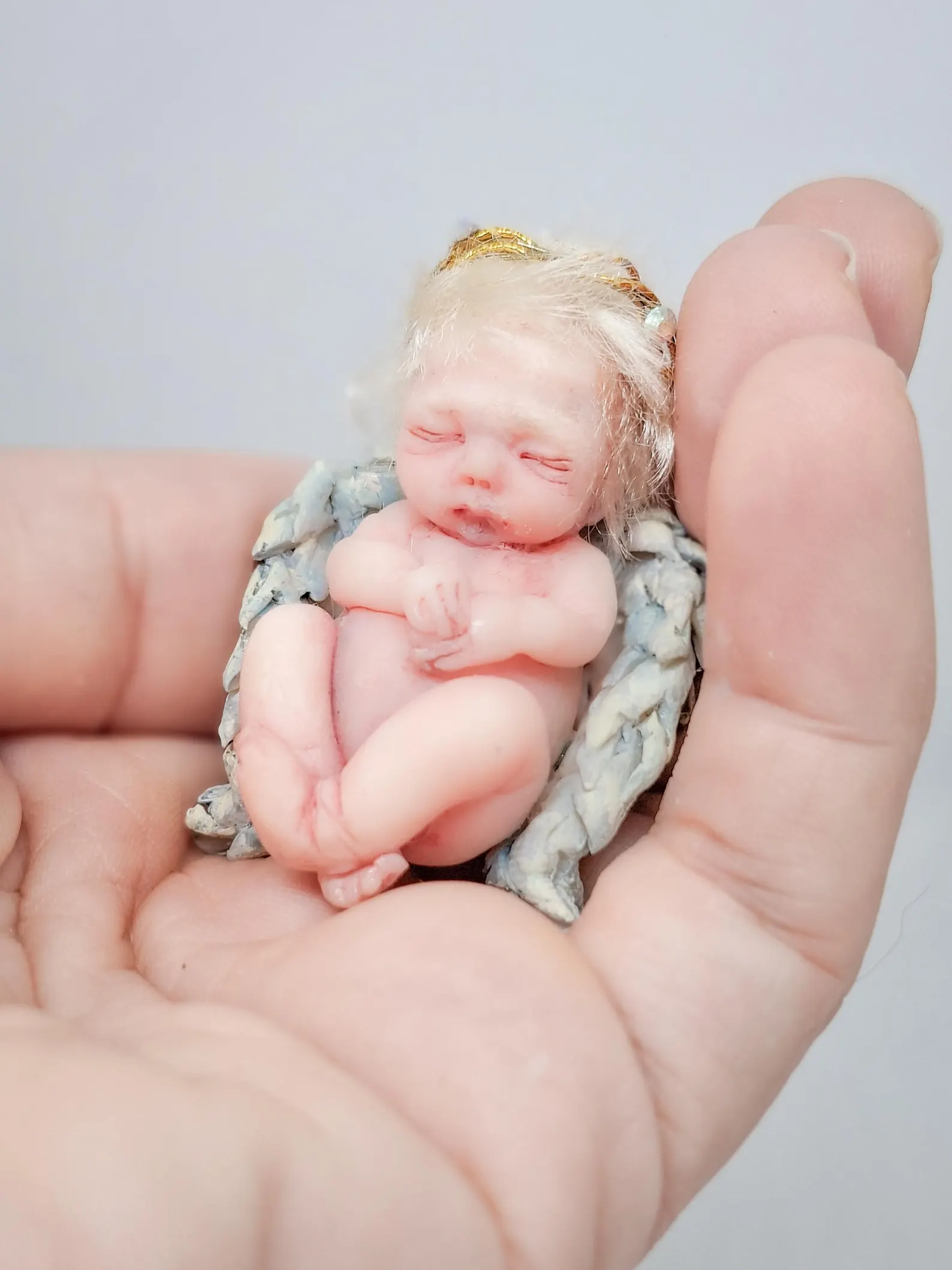 Handmade OOAK miniature angel doll 'The Guardian,' a polymer clay art doll sculpture with protective wings, part of the Divine Collection.
