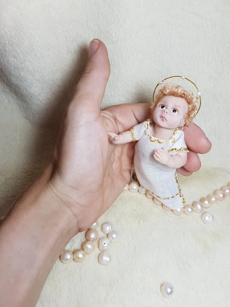 Ethereal OOAK miniature angel baby doll with golden halo and white dress, displayed on white background with pearl beads - by Mini Baby Dolls