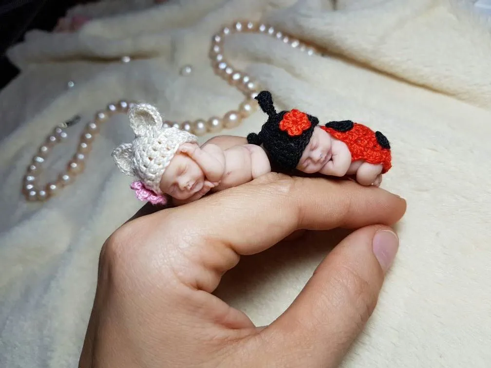 Adorable OOAK miniature baby doll in handmade red and black crocheted ladybug costume with antennae, sleeping peacefully in palm with pearl beads - by Mini Baby Dolls