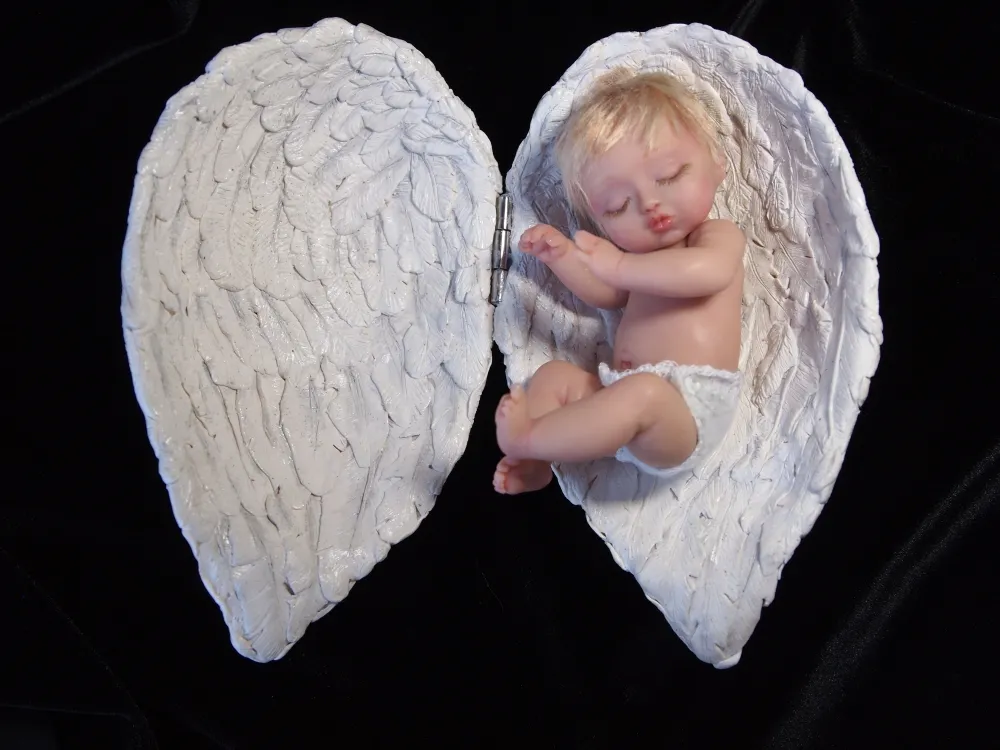 Ethereal OOAK miniature baby doll with delicate sculpted angel wings, displayed on black velvet background - by Mini Baby Dolls