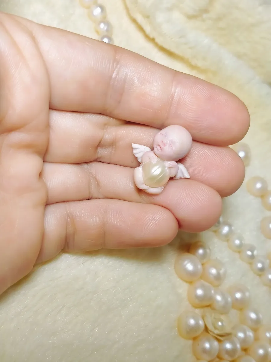 Delicate OOAK miniature angel baby doll with tiny wings in kneeling pose, held in palm with pearl beads - by Mini Baby Dolls