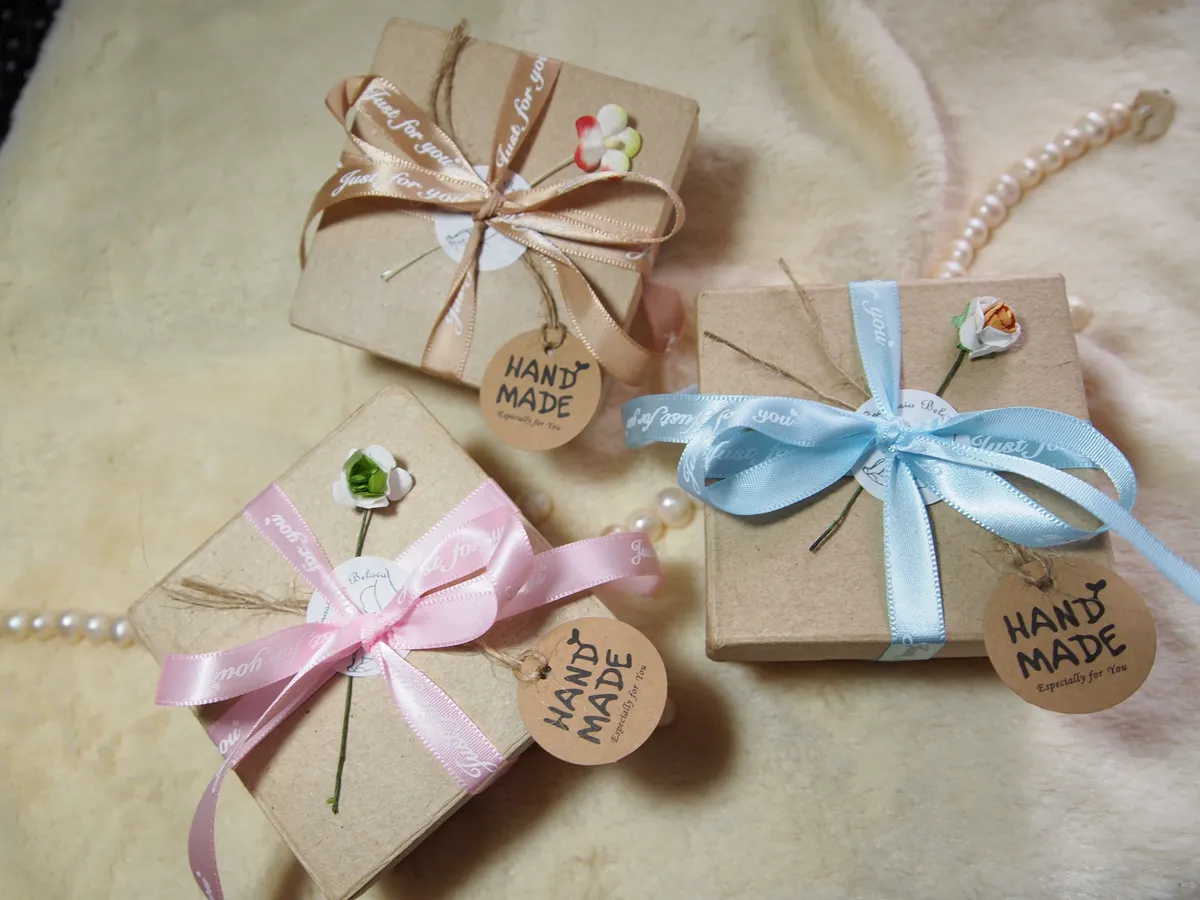 Beautifully packaged OOAK miniature baby dolls in kraft paper gift boxes with handmade tags and ribbon bows - by Mini Baby Dolls