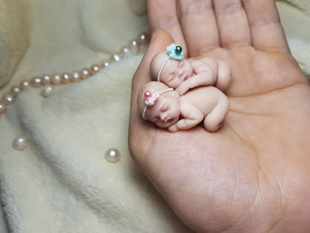 Sleeping OOAK miniature baby doll with tiny pacifier, displayed in palm with pearl necklace accessory - by Mini Baby Dolls