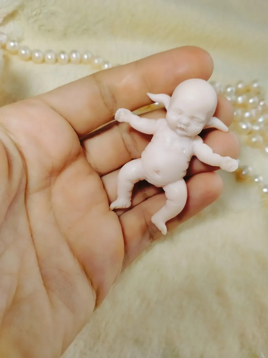 Unpainted OOAK miniature baby doll sculpture in white polymer clay, showing raw sculpting artistry before painting - by Mini Baby Dolls