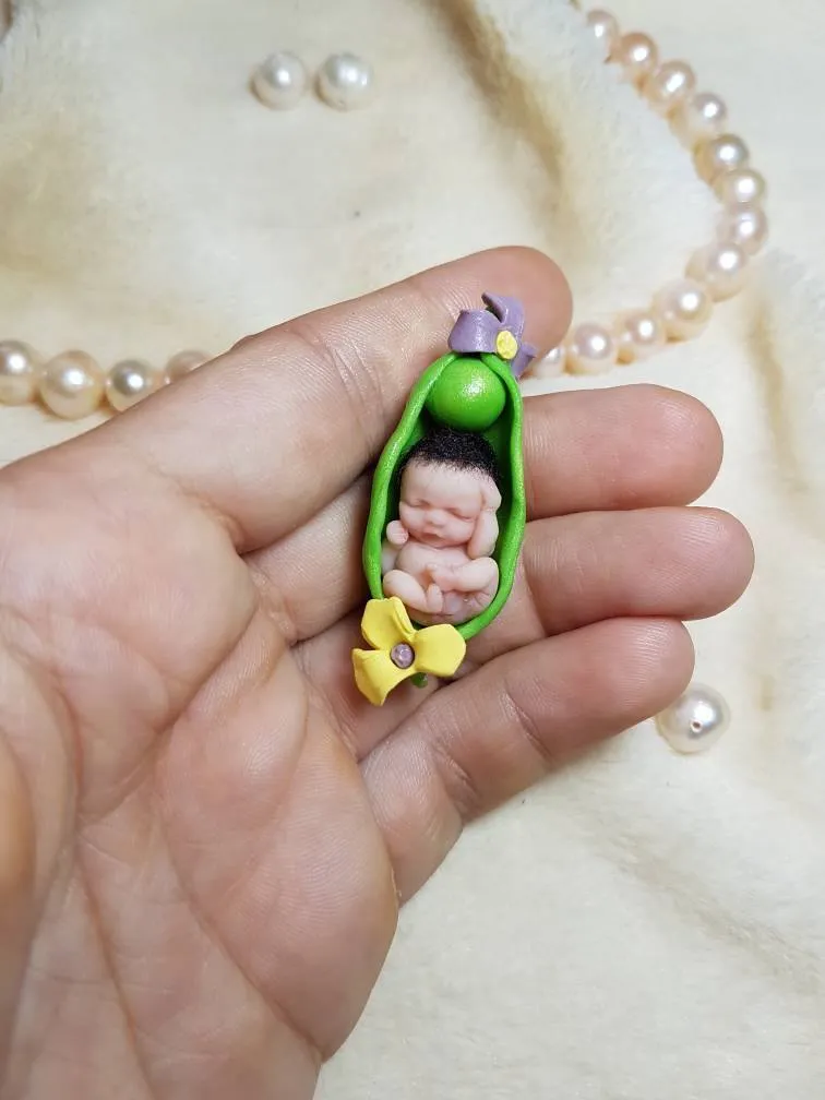 Whimsical OOAK miniature baby doll sleeping inside a green pea pod with yellow flower accent, held in palm with pearl beads - by Mini Baby Dolls